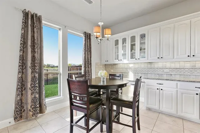 a dining table with chairs and chandelier