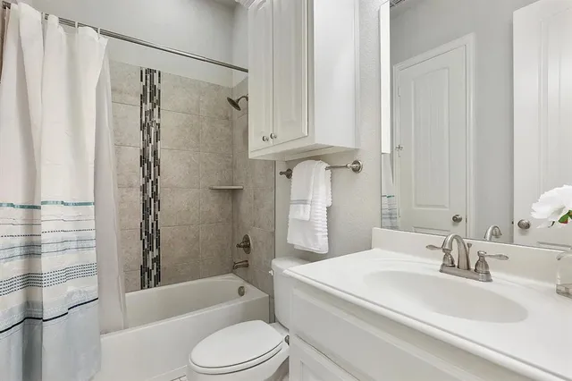 a bathroom with a sink a toilet and a bathtub