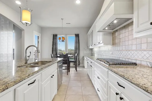 a kitchen with granite countertop stainless steel appliances a sink and counter space