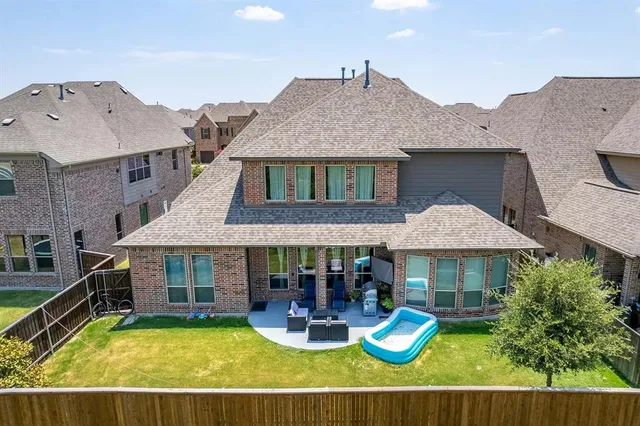 a view of a house with swimming pool and sitting area