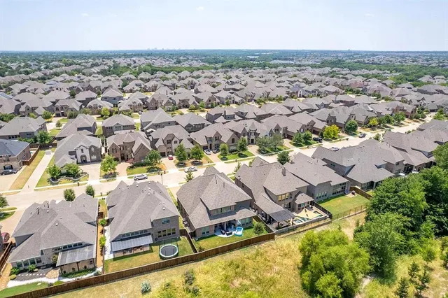 an aerial view of residential houses with outdoor space