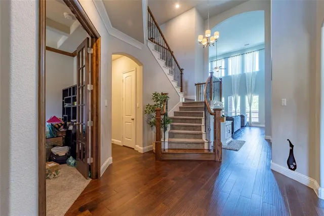 a view of a hallway with wooden floor and stairs