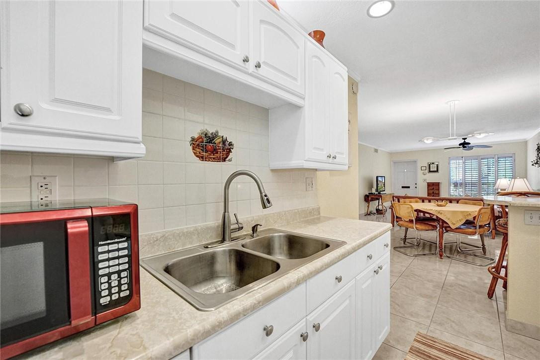 770 East Camino Real, Unit 3 Boca Raton, FL 33432 - Photo 14 of 34 a kitchen with a sink cabinets and window