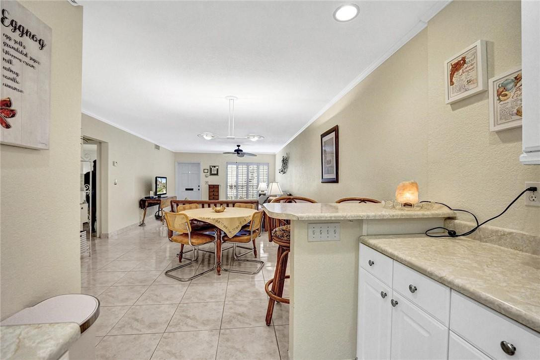 770 East Camino Real, Unit 3 Boca Raton, FL 33432 - Photo 15 of 34 a view of a kitchen area with furniture and chandelier