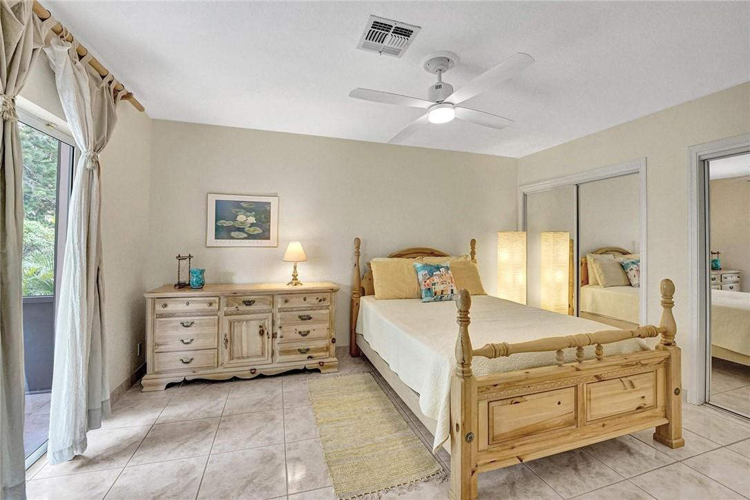 770 East Camino Real, Unit 3 Boca Raton, FL 33432 - Photo 21 of 34 a room with a bed and ceiling fan