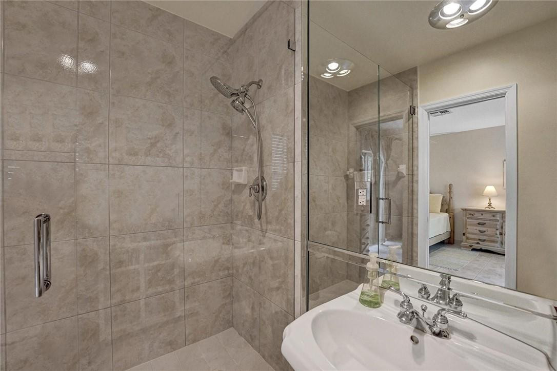 770 East Camino Real, Unit 3 Boca Raton, FL 33432 - Photo 23 of 34 a bathroom with a sink shower and a mirror
