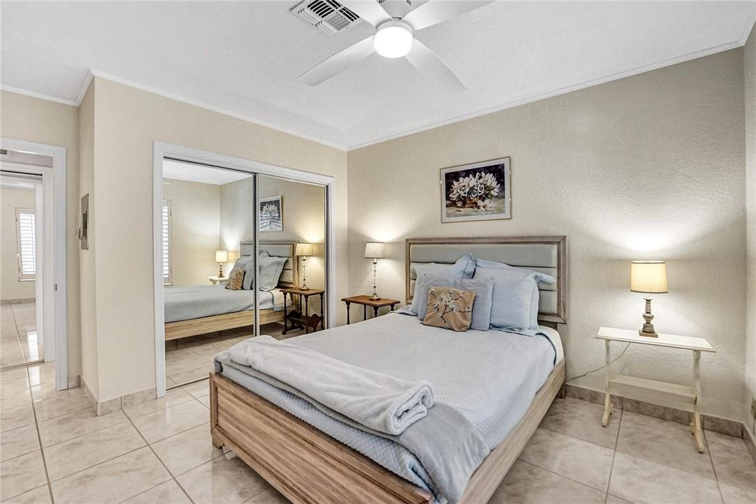 770 East Camino Real, Unit 3 Boca Raton, FL 33432 - Photo 26 of 34 a bedroom with a bed and a view of bathroom