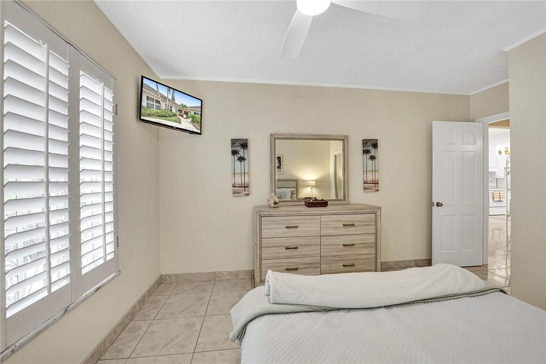 770 East Camino Real, Unit 3 Boca Raton, FL 33432 - Photo 28 of 34 a bedroom with a bed and a dresser