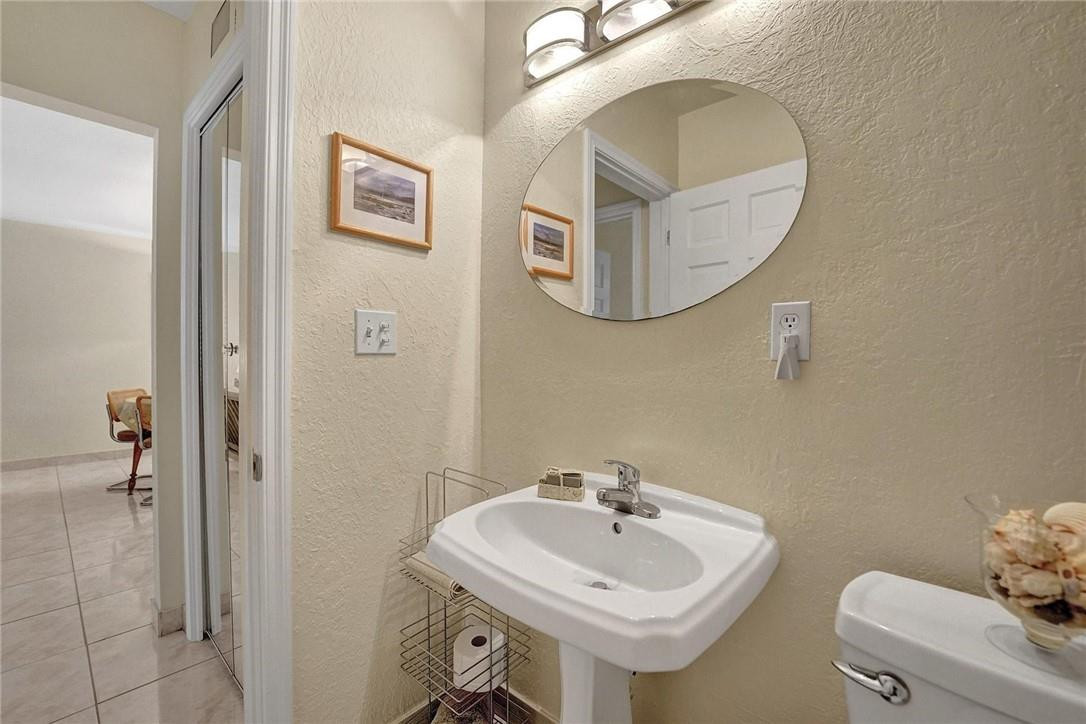 770 East Camino Real, Unit 3 Boca Raton, FL 33432 - Photo 30 of 34 a bathroom with a sink and mirror