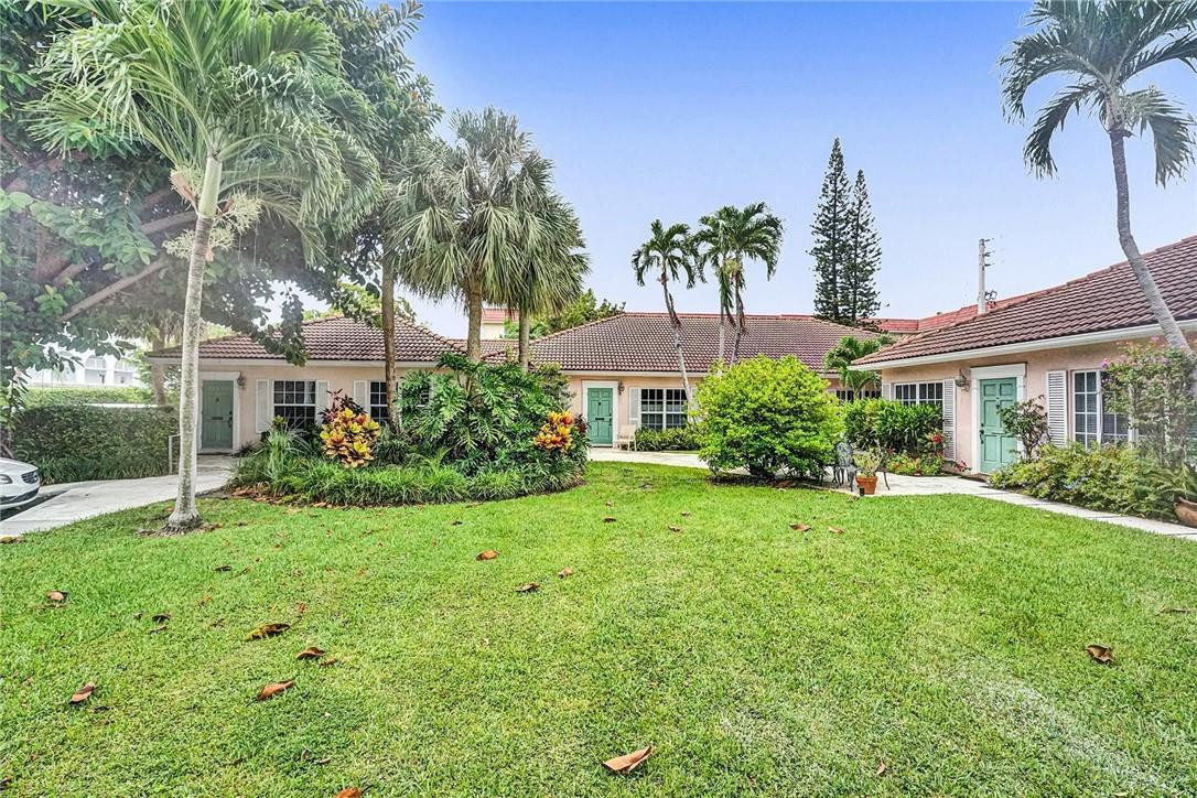 770 East Camino Real, Unit 3 Boca Raton, FL 33432 - Photo 4 of 34 a view of a house with a yard and potted plants