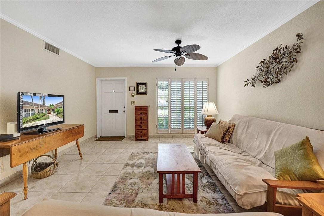 770 East Camino Real, Unit 3 Boca Raton, FL 33432 - Photo 5 of 34 a living room with furniture a window and a flat screen tv