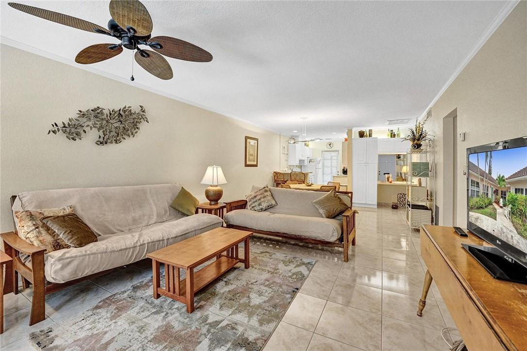 770 East Camino Real, Unit 3 Boca Raton, FL 33432 - Photo 7 of 34 a living room with furniture ceiling fan and a rug