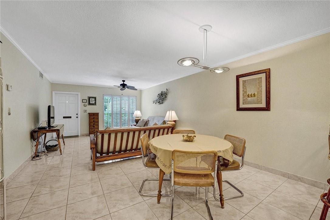 770 East Camino Real, Unit 3 Boca Raton, FL 33432 - Photo 9 of 34 a living room with furniture and a window