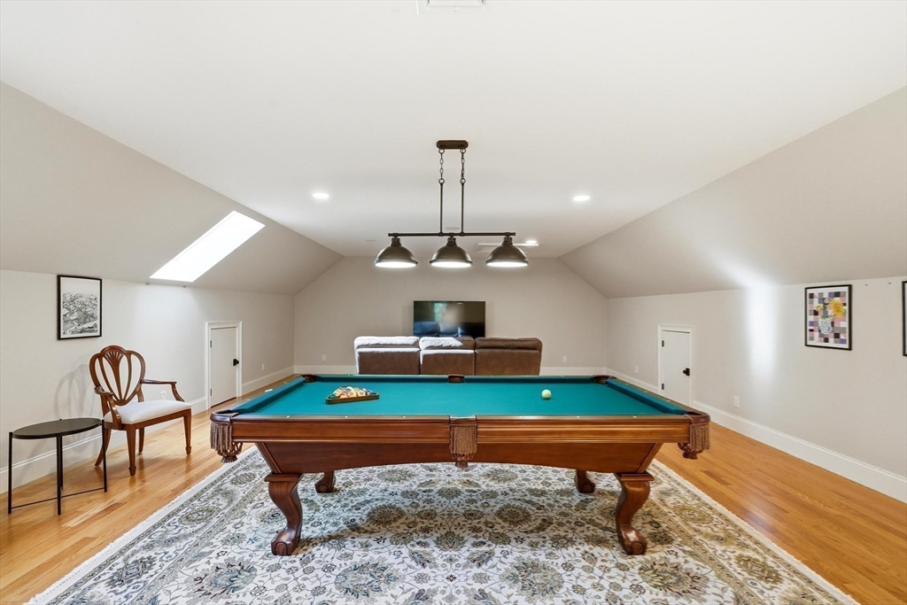 6 Flintlock Road Lexington, MA 02420 - Photo 30 of 39 a room with furniture pool and wooden floor