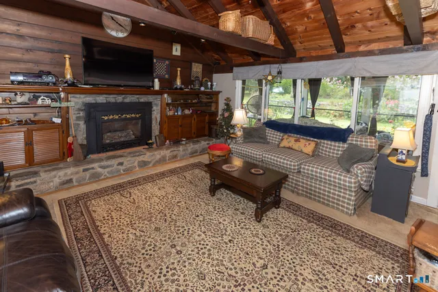 a living room with furniture a flat screen tv and a fireplace