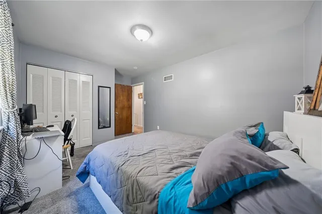 a bedroom with a bed and a chair