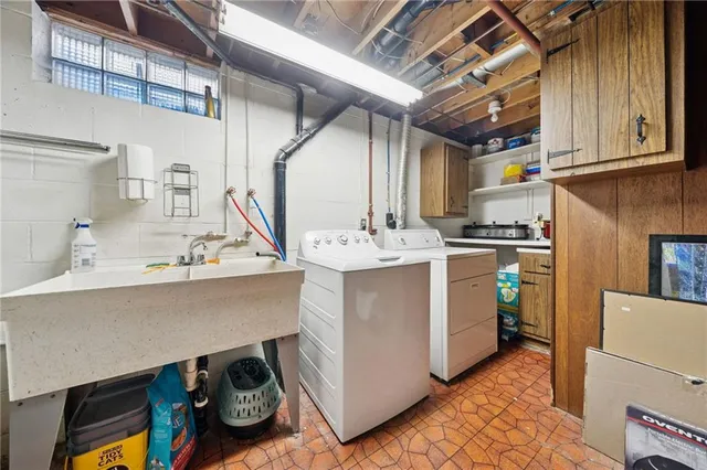 a utility room with cabinets washer and dryer
