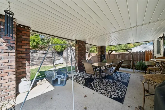 a dining room with balcony furniture and a potted plant