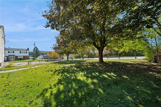a view of yard with swimming pool and green space