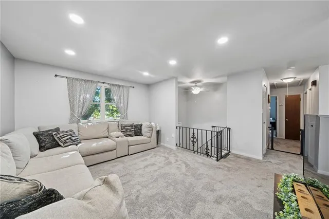 a living room with furniture and a potted plant