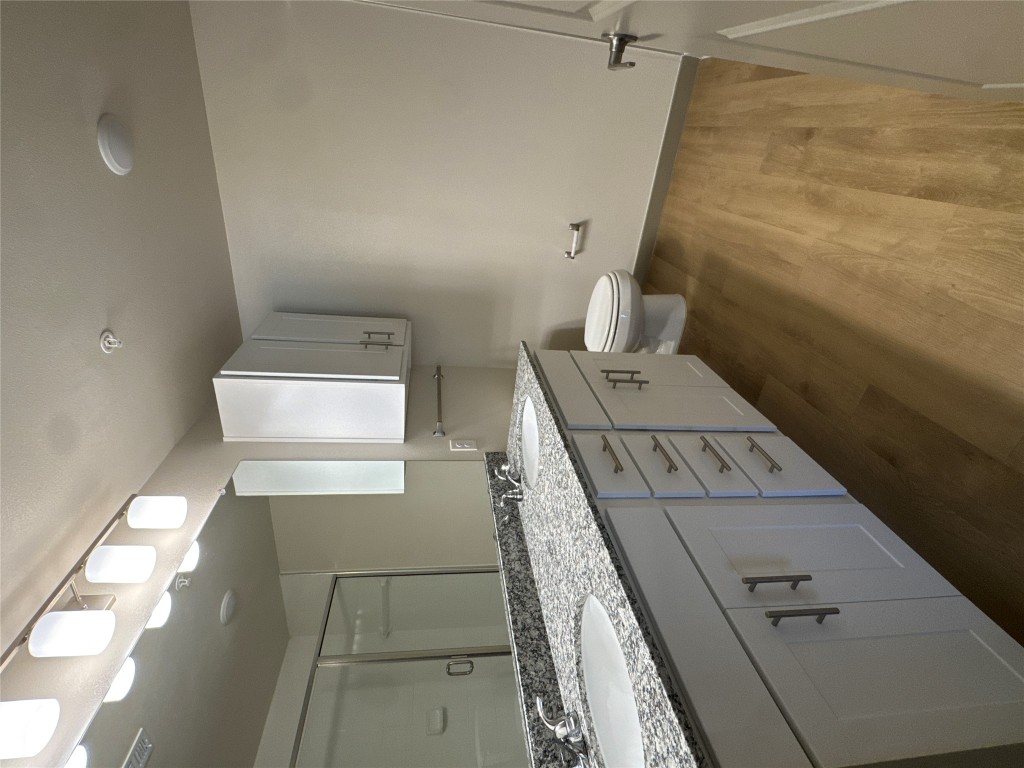 691 Union Chapel Road, Unit C1 Cedar Creek, TX 78612 - Photo 12 of 35 Bathroom with double vanity, a stall shower, and light wood-style flooring