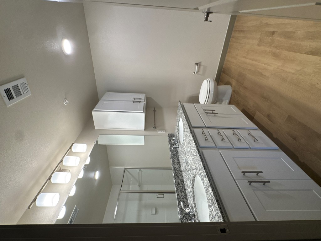 691 Union Chapel Road, Unit C1 Cedar Creek, TX 78612 - Photo 14 of 35 Full bathroom with double vanity, a shower stall, and light wood-style floors