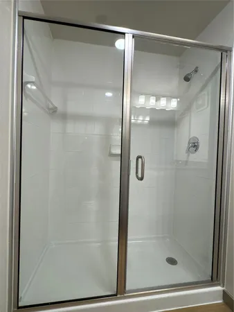 a view of an empty room with closet and bathroom