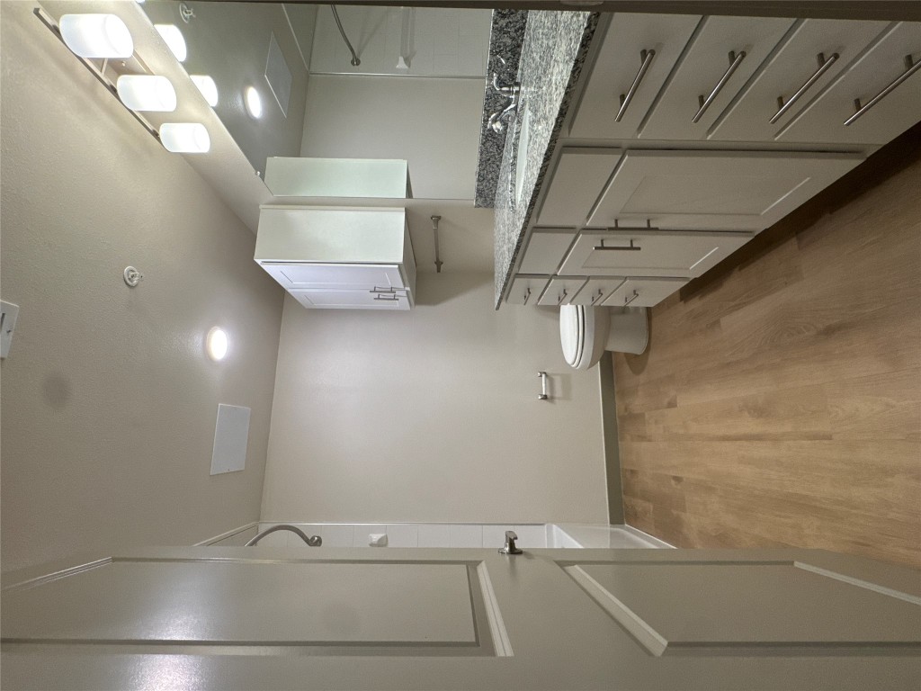 691 Union Chapel Road, Unit C1 Cedar Creek, TX 78612 - Photo 17 of 35 Full bath featuring vanity, light wood-type flooring, and bathtub / shower combination
