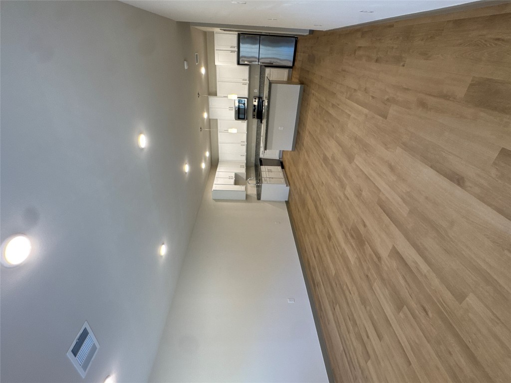691 Union Chapel Road, Unit C1 Cedar Creek, TX 78612 - Photo 22 of 35 Unfurnished living room featuring light wood-style floors and recessed lighting