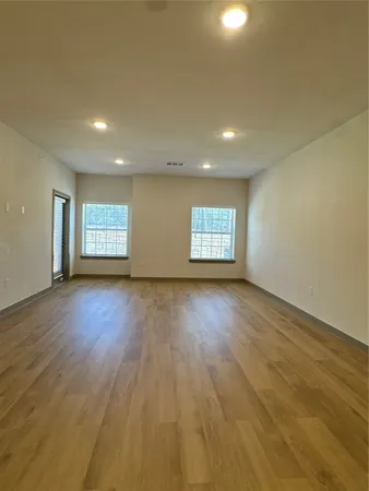 a view of hallway with wooden floor