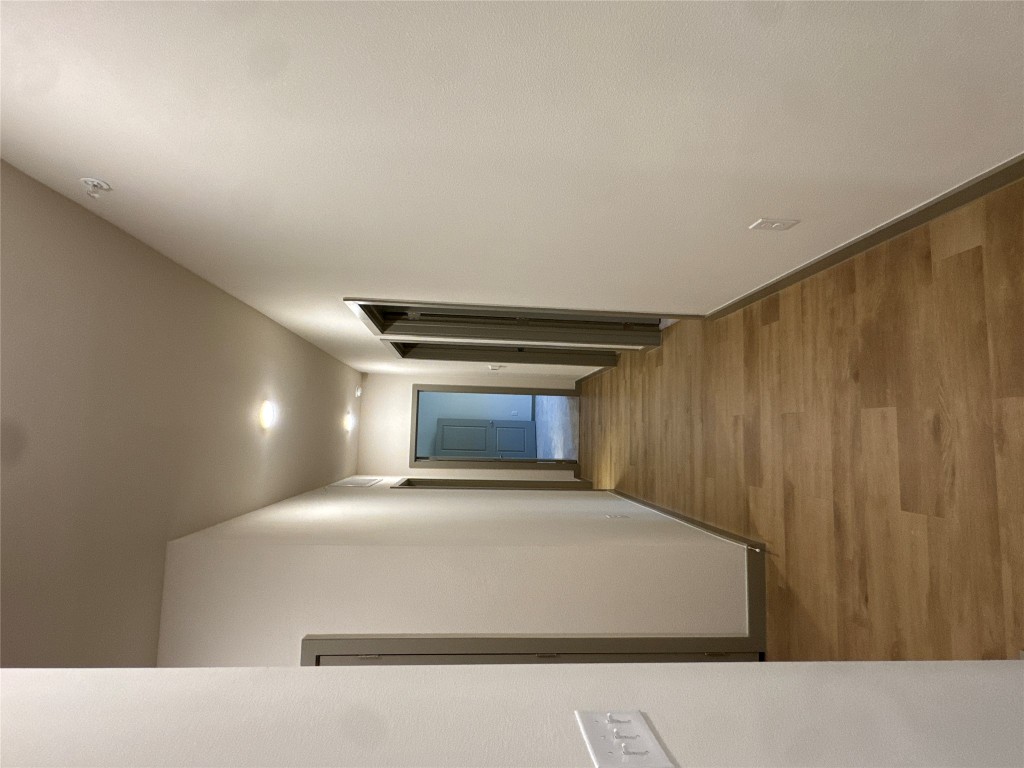691 Union Chapel Road, Unit C1 Cedar Creek, TX 78612 - Photo 5 of 35 Hallway featuring wood style floors