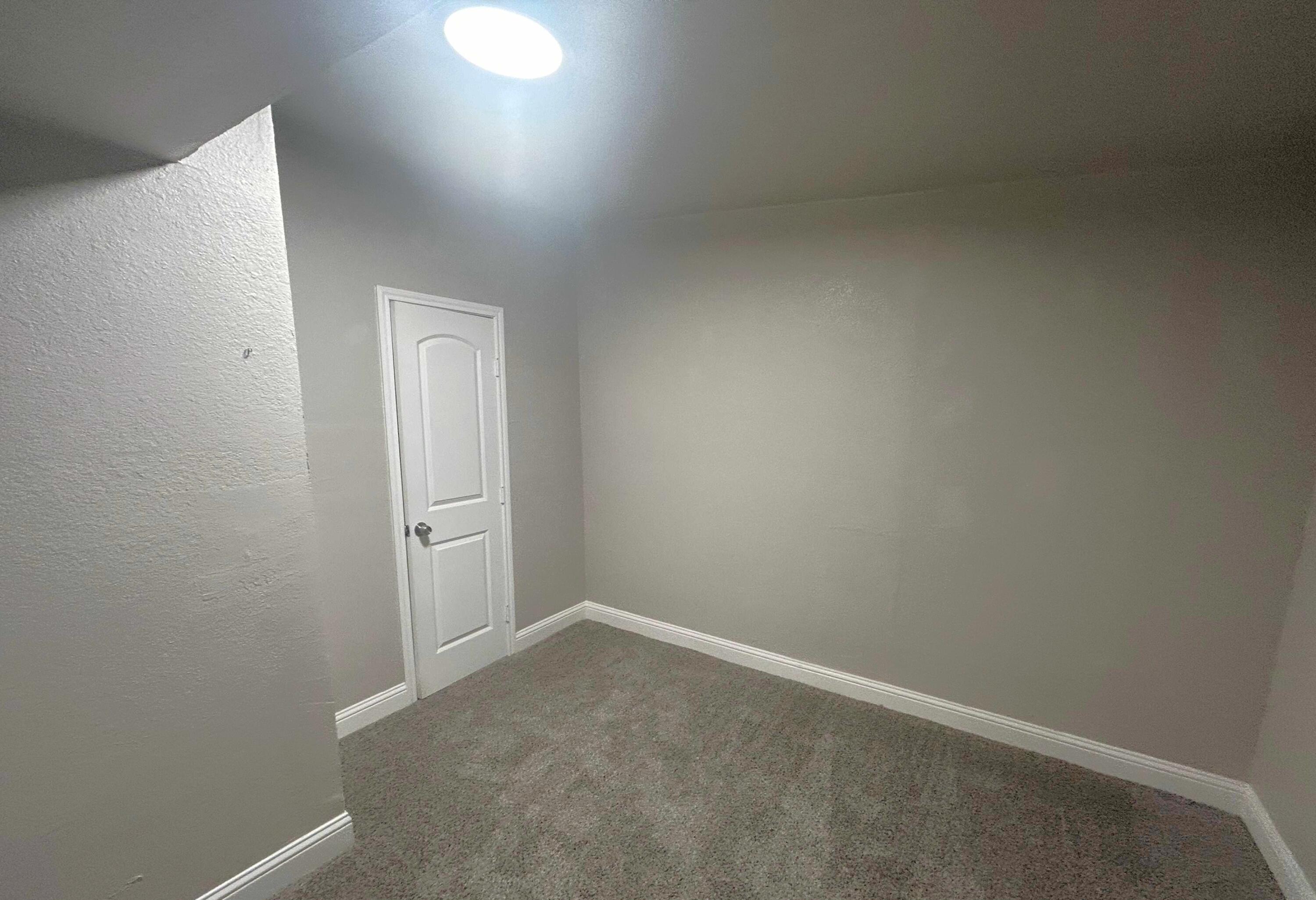 2221 39th Street Lubbock, TX 79412 - Photo 11 of 17 an empty room with a workbench