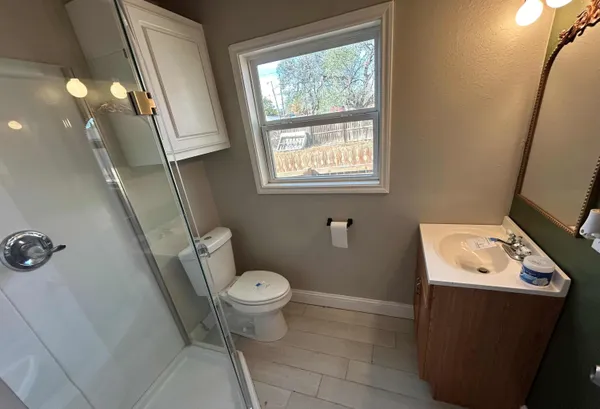 an entryway with wooden floor and a sink