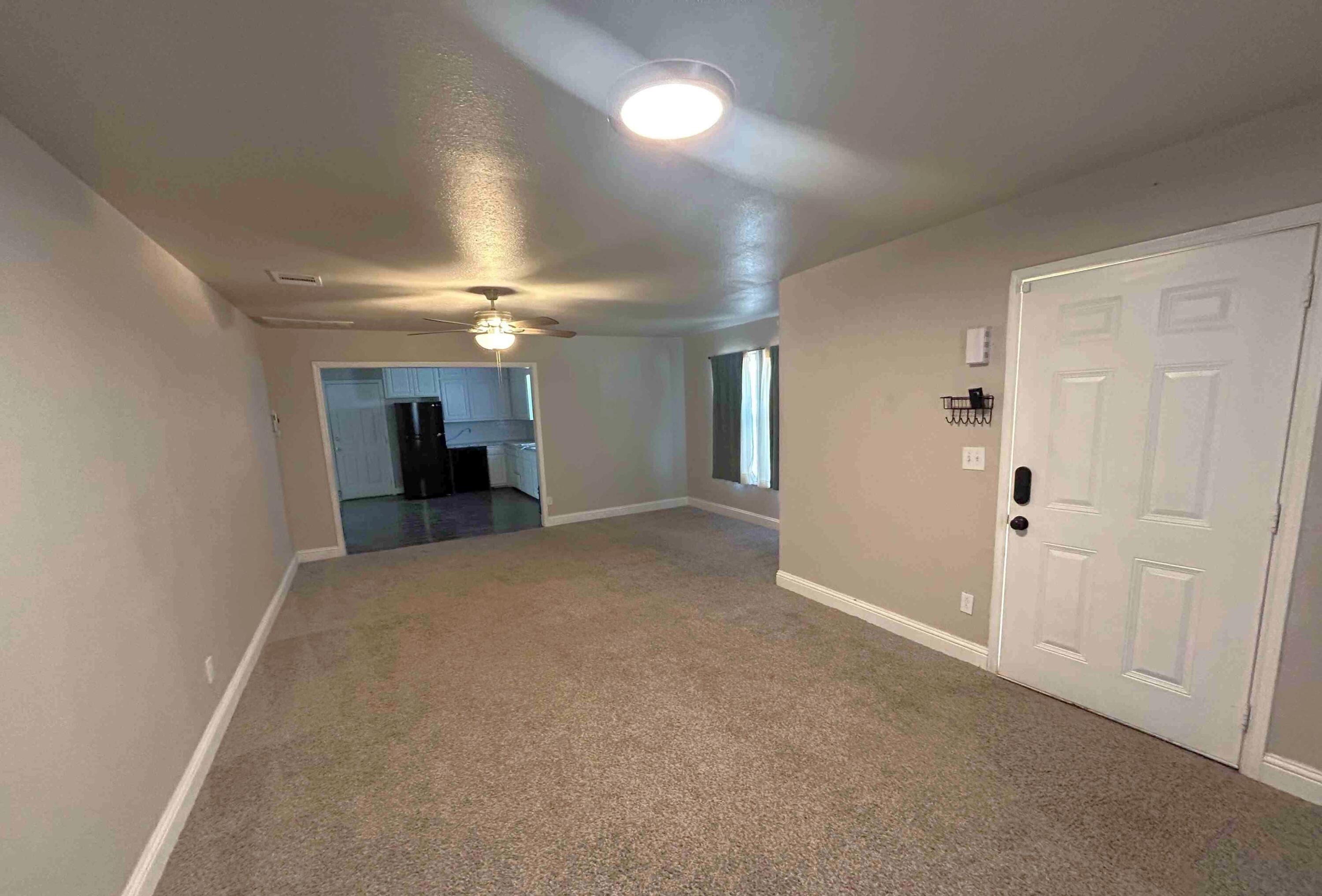 2221 39th Street Lubbock, TX 79412 - Photo 2 of 17 an empty room with a ceiling fan and window