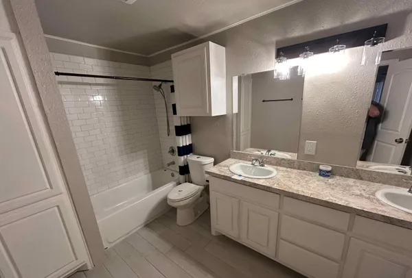 a view of an empty room with a fireplace and a window