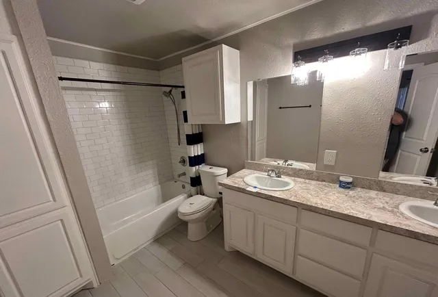 a view of an empty room with a fireplace and a window