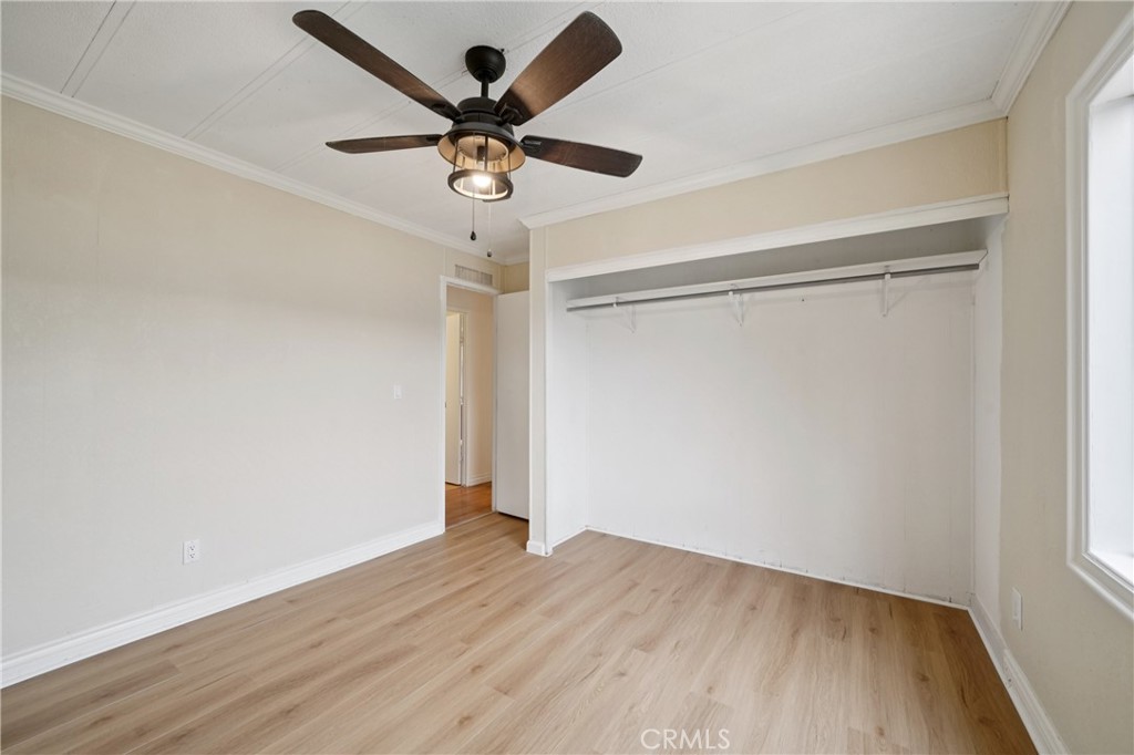 3663 Buchanan Street, Unit 130 Riverside, CA 92503 - Photo 12 of 26 a view of a room with wooden floor and a ceiling fan