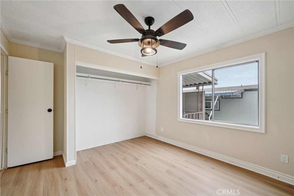 3663 Buchanan Street, Unit 130 Riverside, CA 92503 - Photo 13 of 26 a view of an empty room with wooden floor and a window