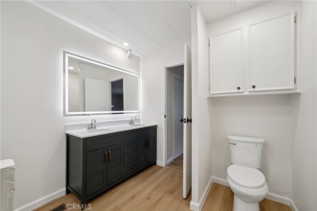 3663 Buchanan Street, Unit 130 Riverside, CA 92503 - Photo 17 of 26 a bathroom with a toilet sink and mirror