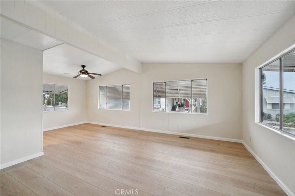 3663 Buchanan Street, Unit 130 Riverside, CA 92503 - Photo 2 of 26 a view of an empty room with a window and wooden floor