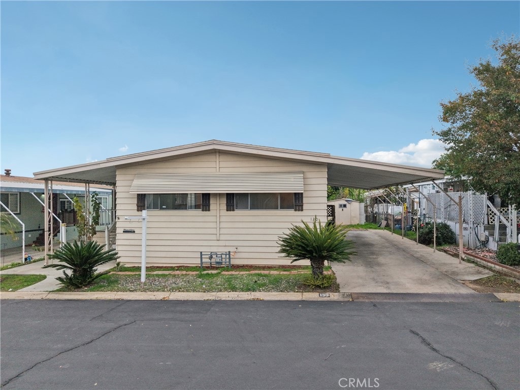 3663 Buchanan Street, Unit 130 Riverside, CA 92503 - Photo 25 of 26 a front view of a house with a yard and garage