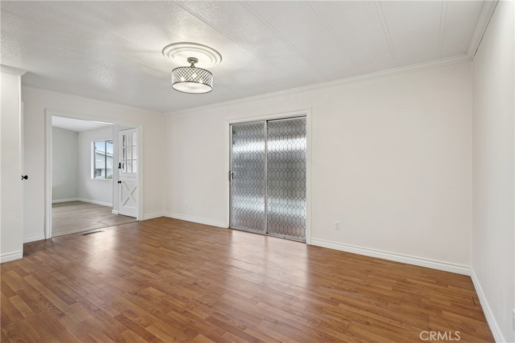 3663 Buchanan Street, Unit 130 Riverside, CA 92503 - Photo 9 of 26 an empty room with wooden floor and mirror