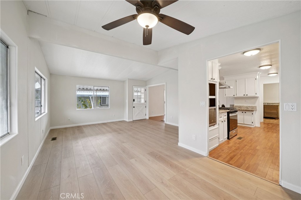 3663 Buchanan Street, Unit 130 Riverside, CA 92503 - Photo 10 of 26 a view of kitchen and empty room with wooden floor