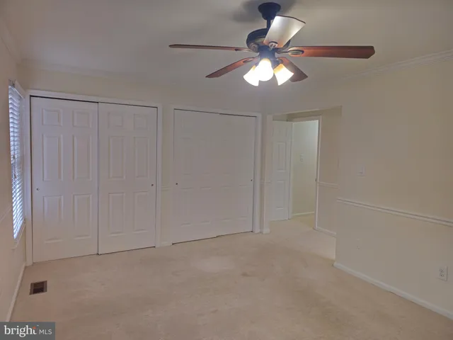 a bathroom with a toilet a sink a mirror a bathtub and vanity