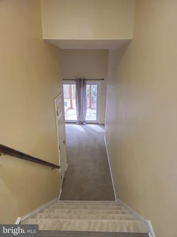 a view of an empty room with a fireplace and a window