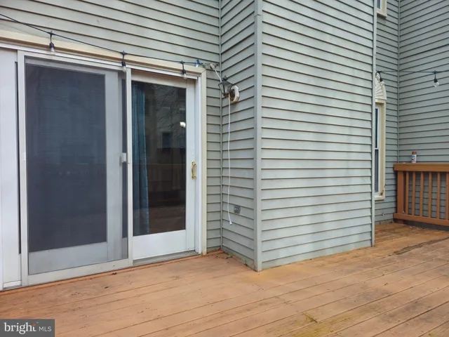 a balcony with wooden floor and trees