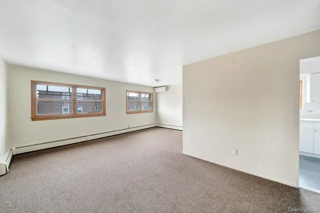 a view of an empty room with a kitchen