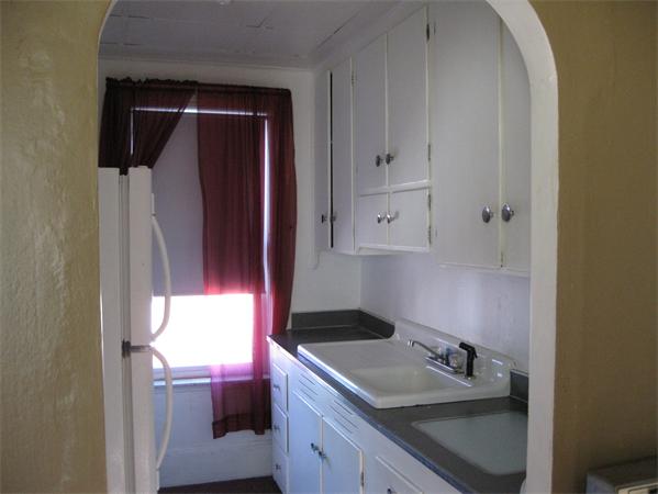 497 Ridge Street Fall River, MA 02724 - Photo 7 of 20 a kitchen with a sink and a stove