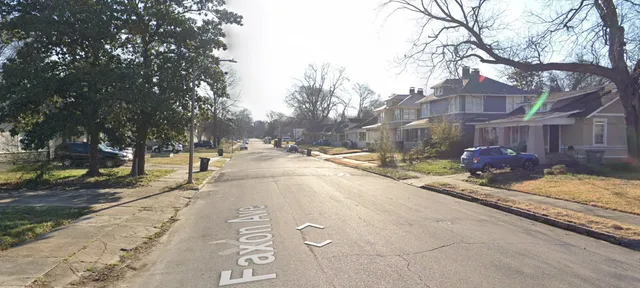 a view of a street with a tree