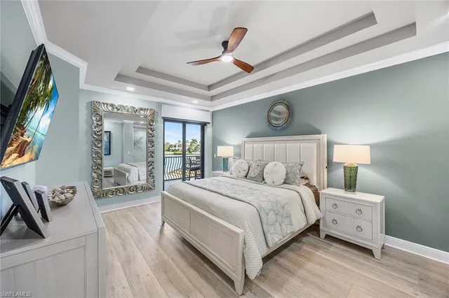 a bedroom with a large bed and a tv